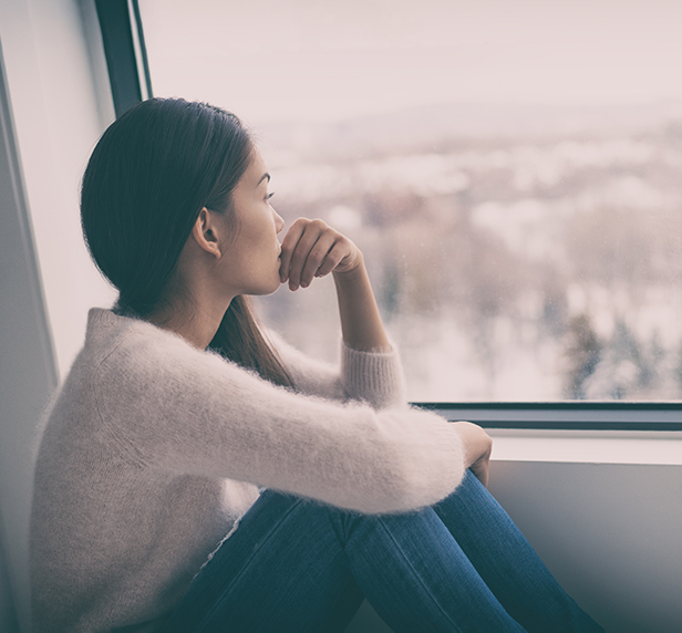 A women looks out of the window, wondering if she could benefit from Individual Therapy