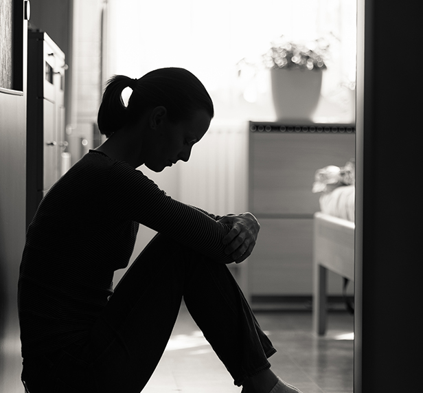 A women sitting in the bathroom after making herself throw up. She's suffering from bulimia