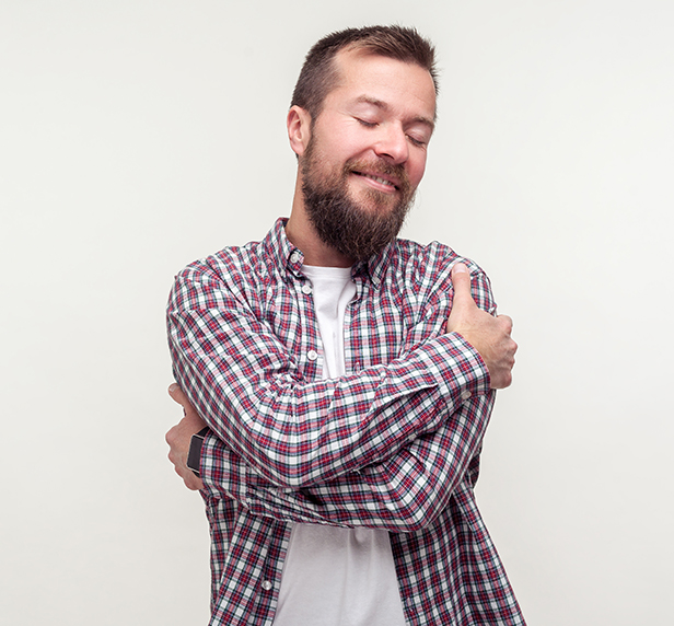 A man looks very happy with himself after boosting his self esteem