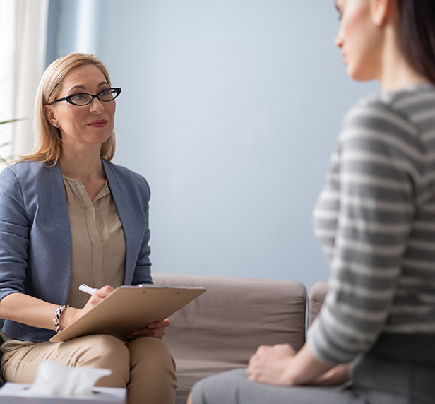 A therapist sits with a patient through a psychological assessment