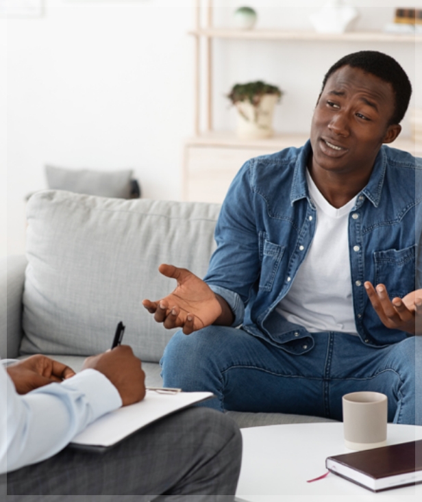 A man asking his therapist about using insurance for mental health treatments.