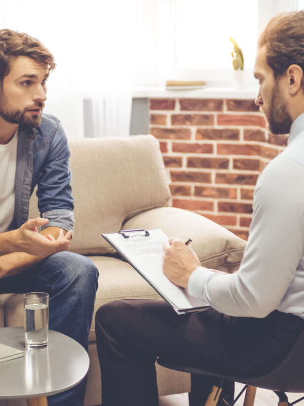 A man sits with his therapist during a therapy session with Viewpoint Psychology & Wellness